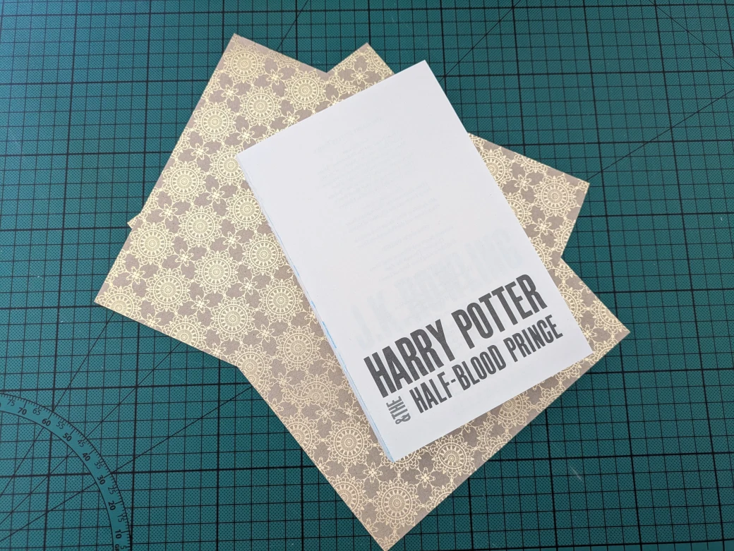 Textblock of a Harry Potter book lying on top of gold endpapers.